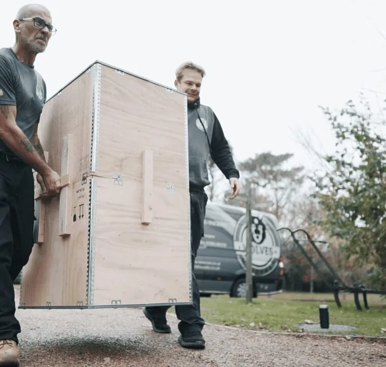 Two Wolves Storage Sussex movers carrying a wooden storage container to the van &mdash; Wolves Storage Sussex serving Brighton