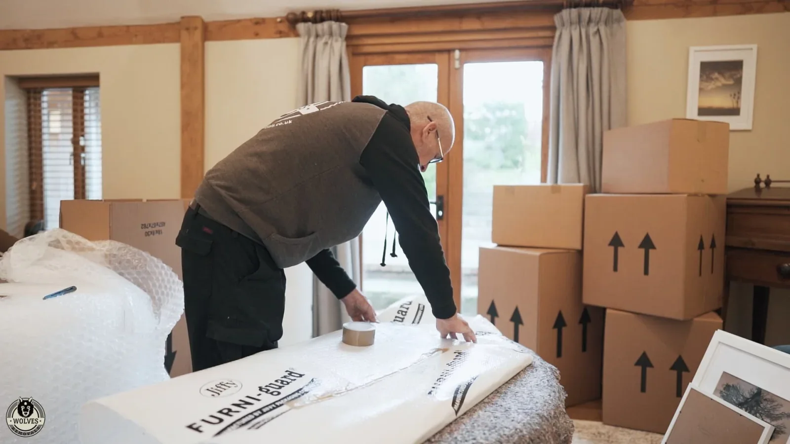Wolves Storage Sussex packer wrapping furniture in Furni-guard padding before secure storage &mdash; storage in Cowfold, West Sussex