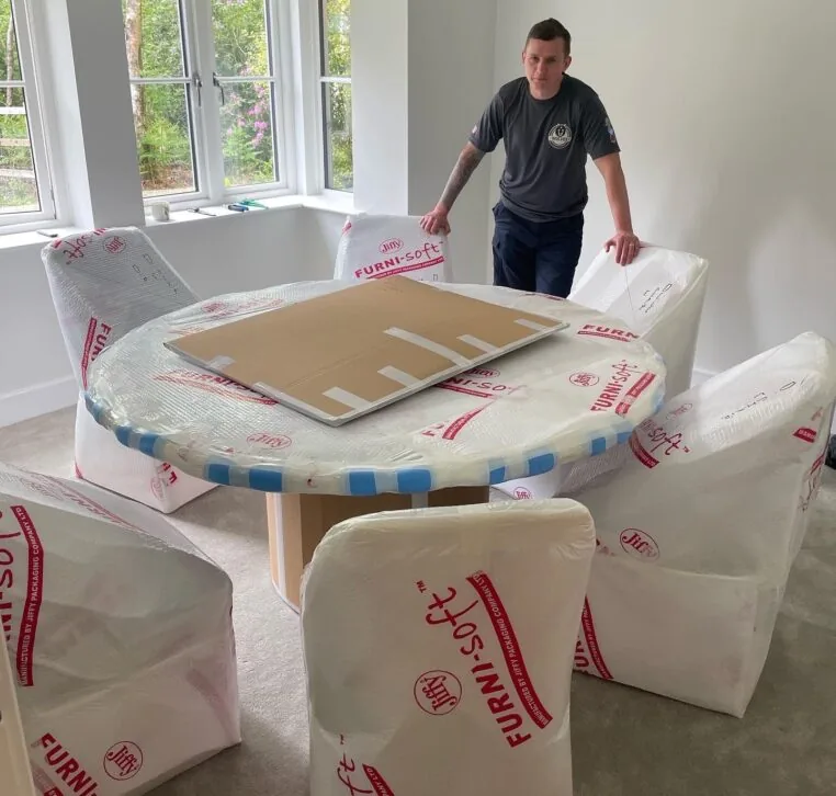 A dining table and chairs wrapped in Furni-soft padding by Wolves Storage Sussex