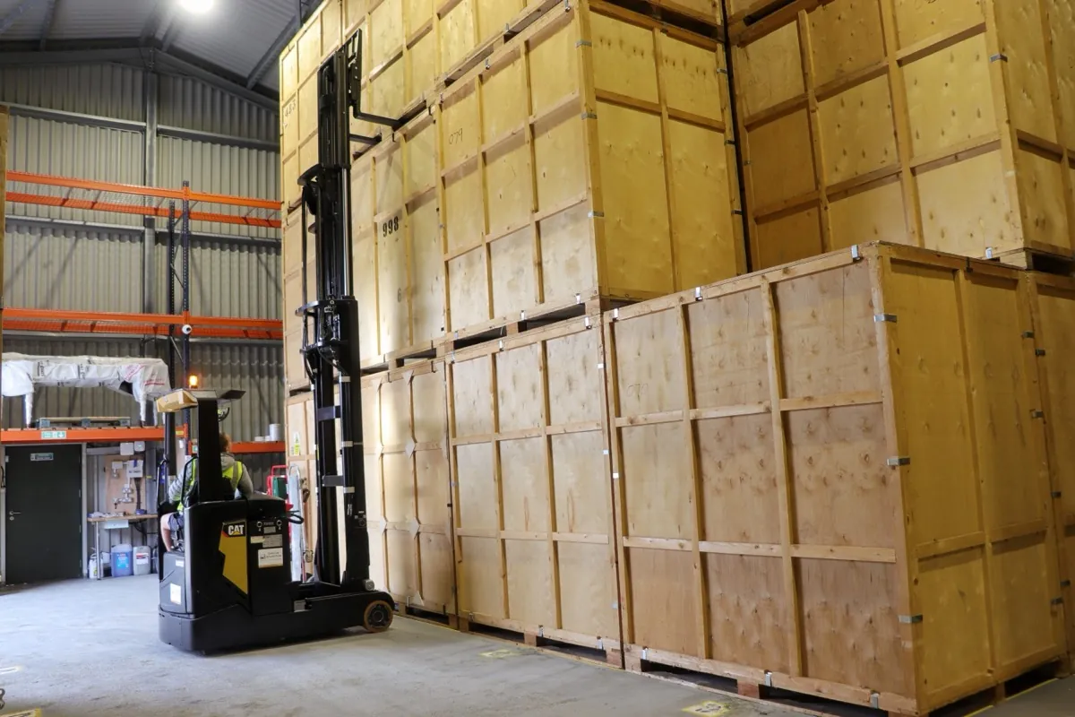 Inside the secure, alarmed Wolves Storage Sussex warehouse with containers and forklift