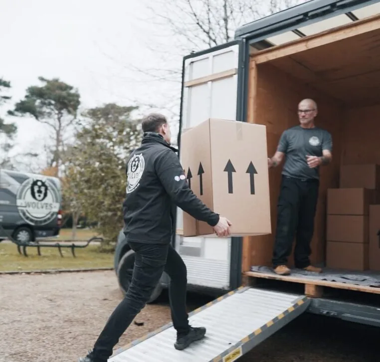 Wolves Storage Sussex movers loading packed boxes up the ramp into the van