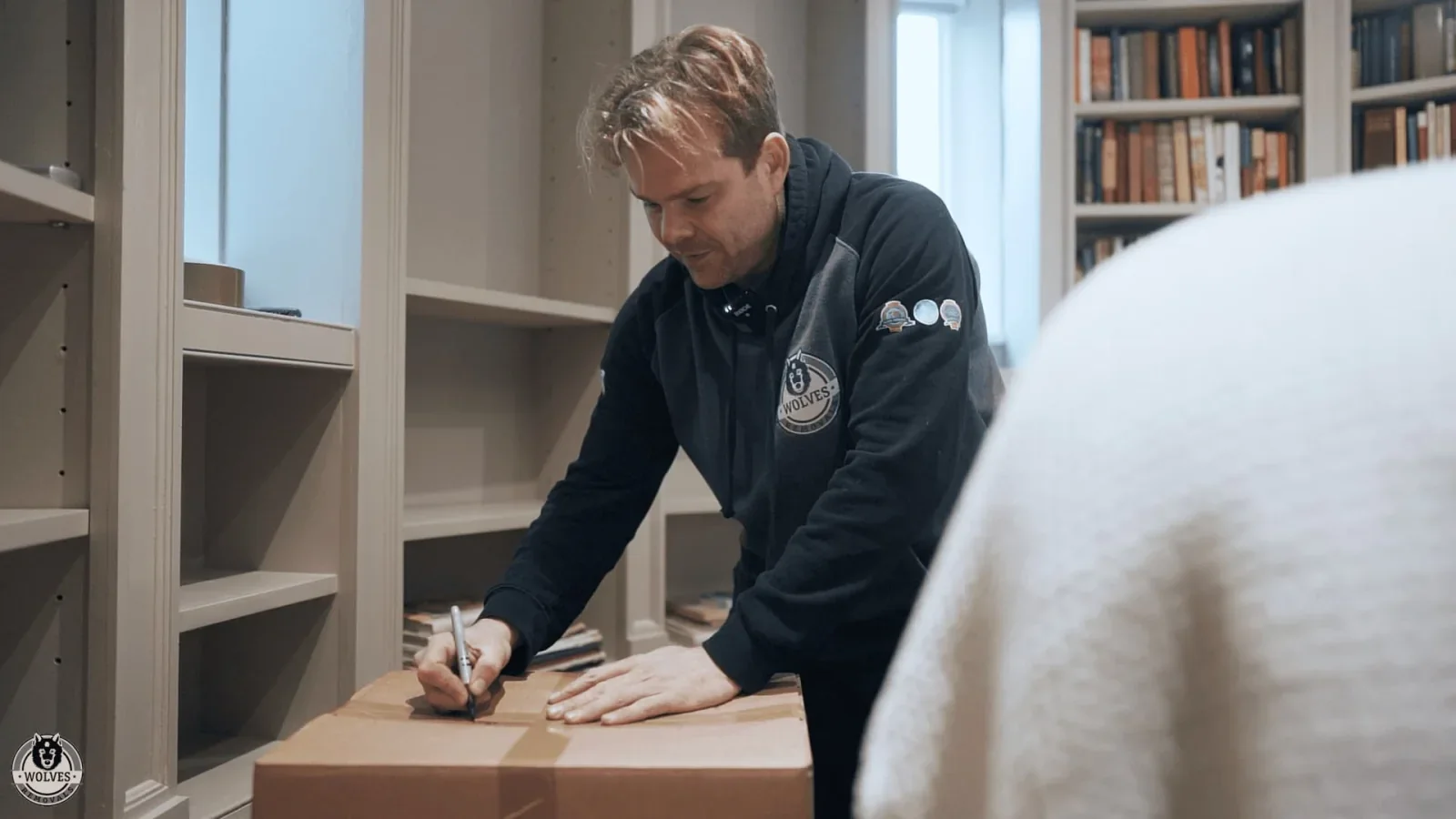Wolves Storage Sussex packer labelling a carefully packed box during a professional home pack &mdash; storage in Brighton, East Sussex