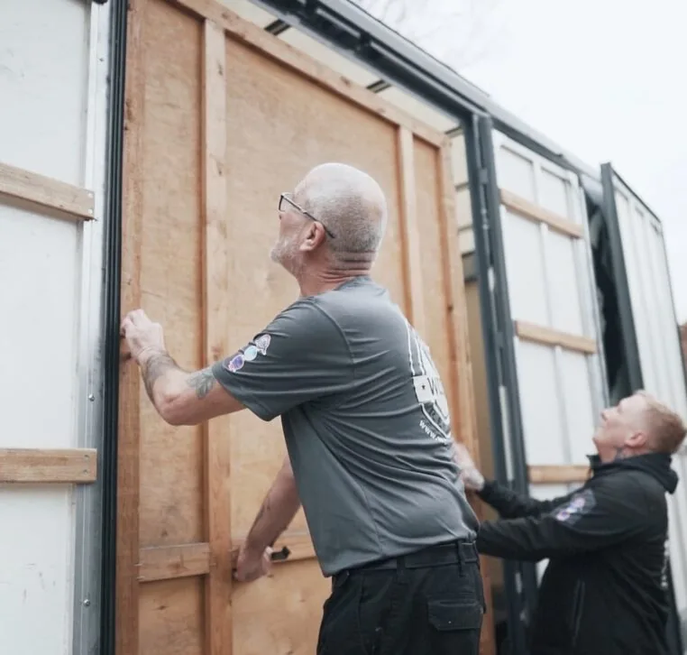 Wolves Storage Sussex movers positioning a sealed wooden storage container